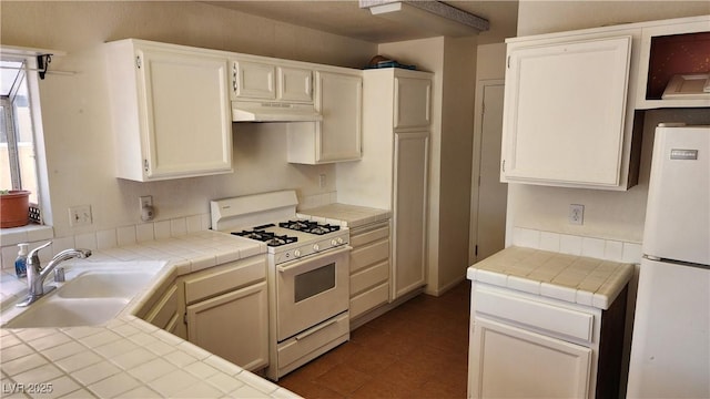 4285 El Como Way, Las Vegas, NV 89121 - kitchen featuring white appliances, under cabinet range hood, tile countertops, and white cabinets