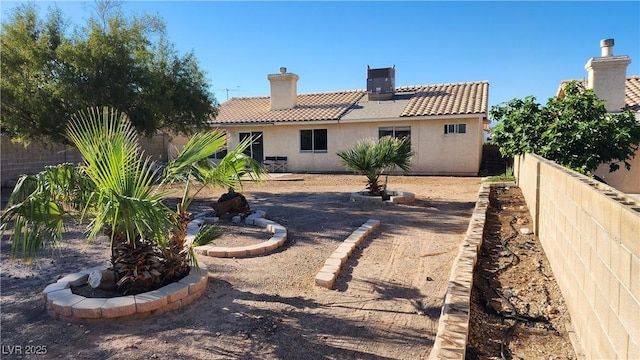 4285 El Como Way, Las Vegas, NV 89121 - rear view of property with a tile roof, stucco siding, a chimney, and a fenced backyard