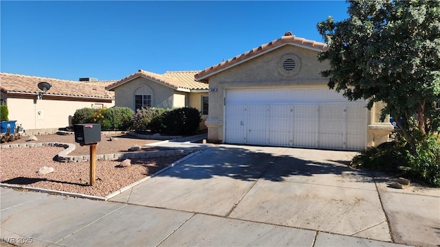 4285 El Como Way, Las Vegas, NV 89121 - view of front facade with driveway, stucco siding, a garage, and a tile roof
