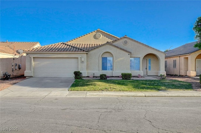 mediterranean / spanish house featuring an attached garage, driveway, stucco siding, and a tiled roof