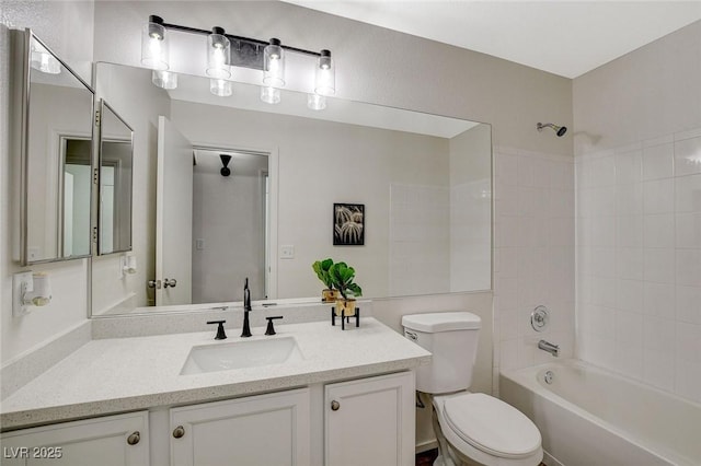 bathroom featuring toilet, vanity, and shower / bath combination