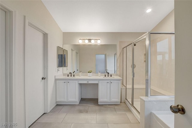 bathroom with tile patterned floors, a stall shower, and double vanity