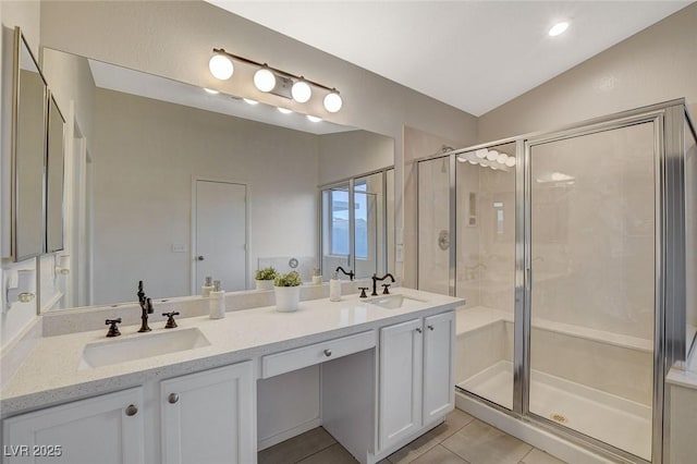 full bath featuring a stall shower, tile patterned flooring, and double vanity