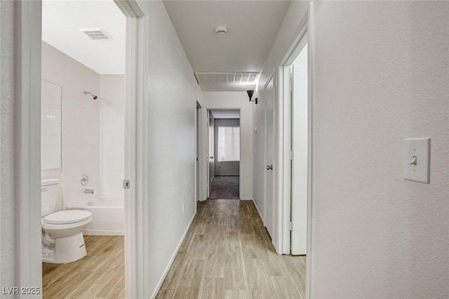 corridor featuring light wood finished floors