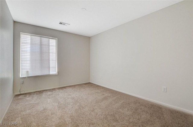 empty room featuring carpet flooring and baseboards