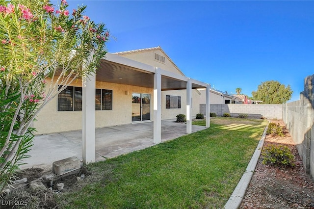 back of house featuring stucco siding and a patio area