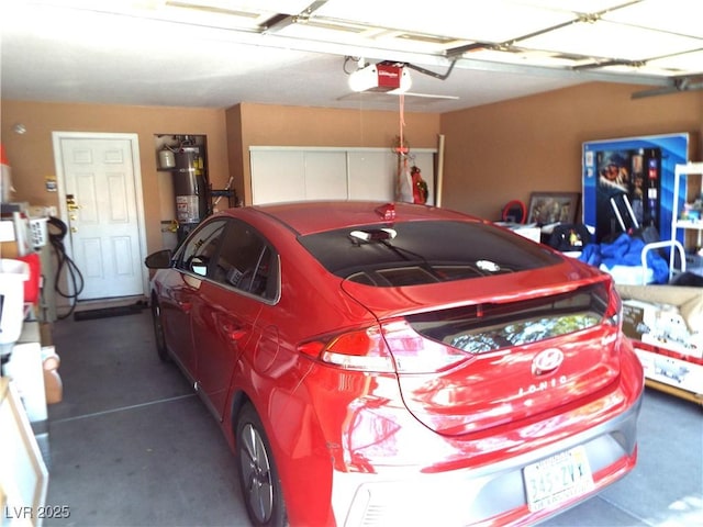 3954 Saddlewood Ct, Las Vegas, NV 89121 - garage with a garage door opener and secured water heater