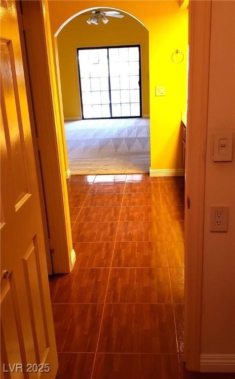 3954 Saddlewood Ct, Las Vegas, NV 89121 - hall with arched walkways, dark carpet, and baseboards