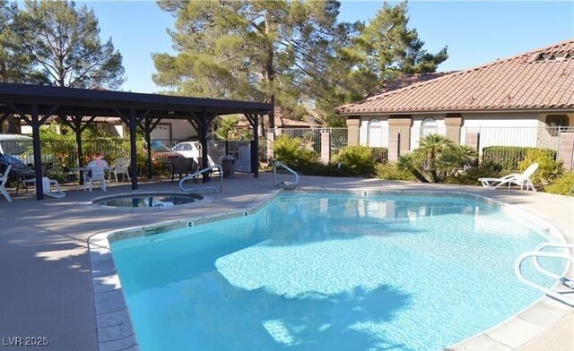 3954 Saddlewood Ct, Las Vegas, NV 89121 - community pool featuring fence, a hot tub, and a patio area