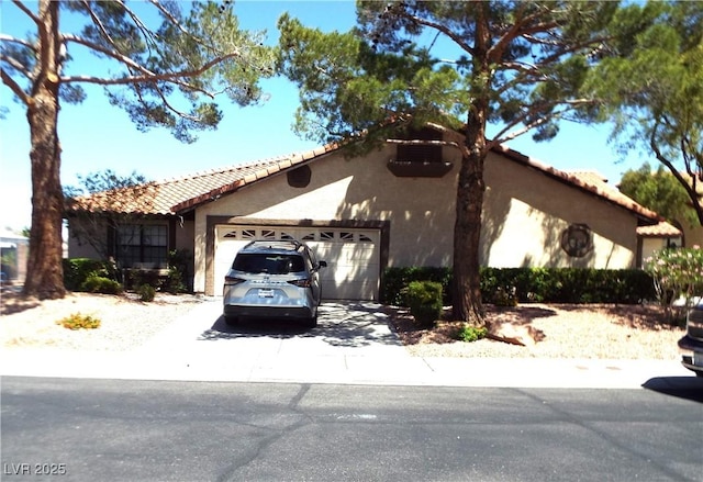 3954 Saddlewood Ct, Las Vegas, NV 89121 - mediterranean / spanish house with an attached garage, stucco siding, a tiled roof, and driveway