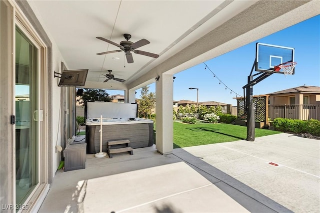 view of patio with a ceiling fan and a hot tub