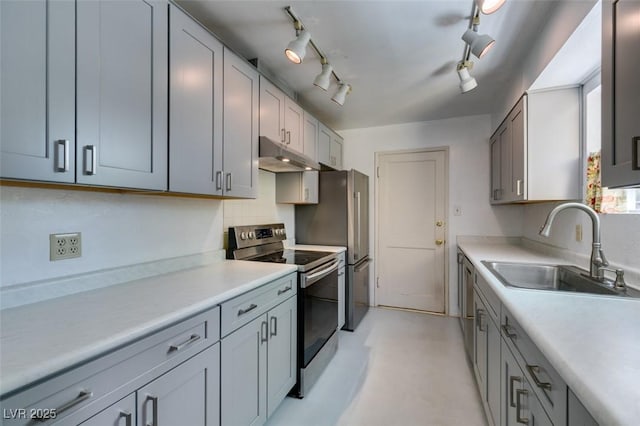 1127 Melville Dr, Las Vegas, NV 89102 - kitchen with appliances with stainless steel finishes, a sink, under cabinet range hood, and light countertops
