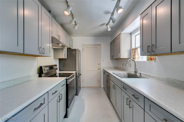 1127 Melville Dr, Las Vegas, NV 89102 - kitchen featuring stainless steel appliances, a sink, under cabinet range hood, light countertops, and backsplash