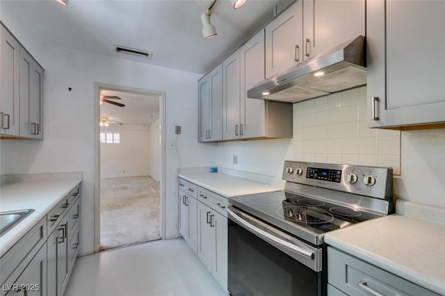 1127 Melville Dr, Las Vegas, NV 89102 - kitchen with electric range, under cabinet range hood, ceiling fan, decorative backsplash, and light countertops
