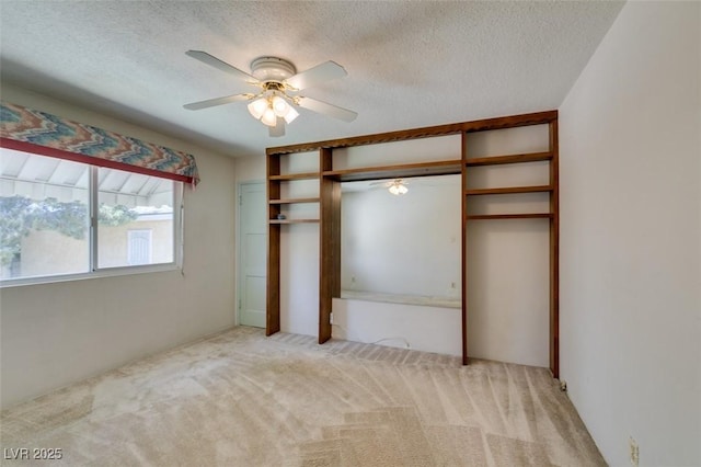 1127 Melville Dr, Las Vegas, NV 89102 - unfurnished bedroom with light colored carpet, a textured ceiling, a closet, and a ceiling fan