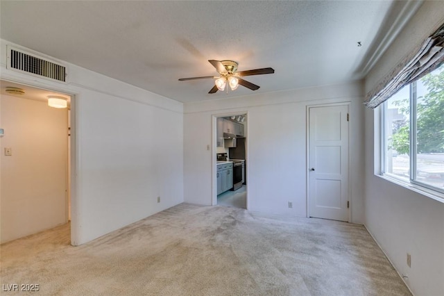 1127 Melville Dr, Las Vegas, NV 89102 - unfurnished living room with light colored carpet and a ceiling fan