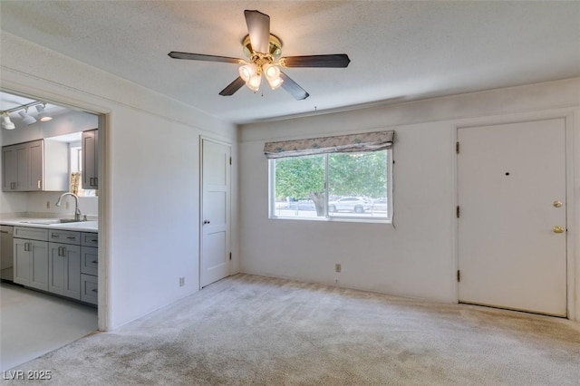 1127 Melville Dr, Las Vegas, NV 89102 - unfurnished living room featuring a sink, light colored carpet, and ceiling fan
