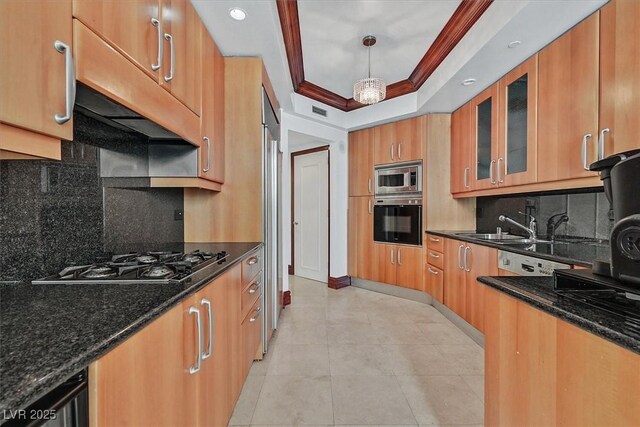 kitchen with appliances with stainless steel finishes, glass insert cabinets, decorative backsplash, dark stone countertops, and light tile patterned flooring
