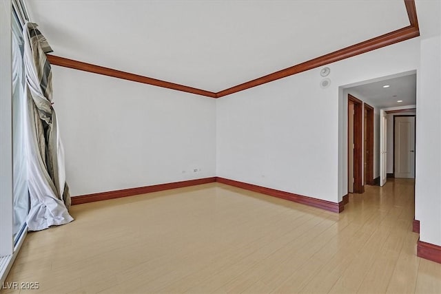unfurnished room with ornamental molding, baseboards, light wood-style floors, and recessed lighting