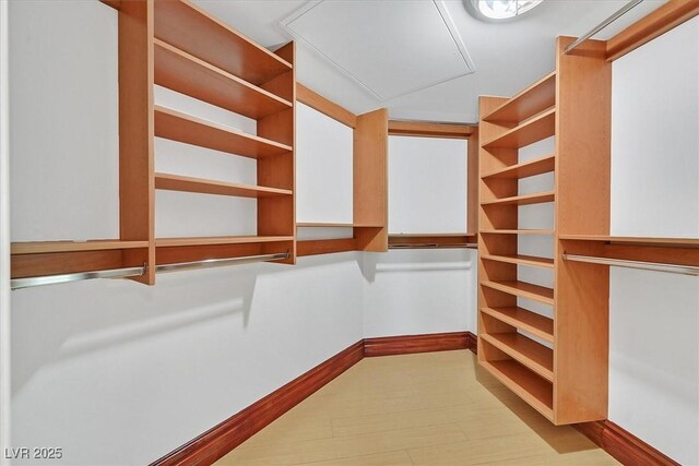 walk in closet featuring attic access