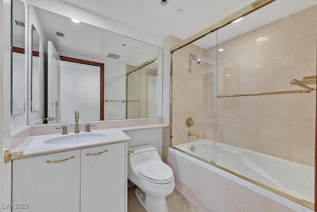 full bath with toilet, vanity, bath / shower combo with glass door, and tile patterned floors