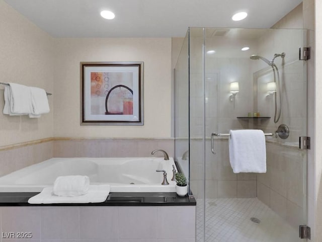 full bathroom featuring a garden tub, a shower stall, and recessed lighting