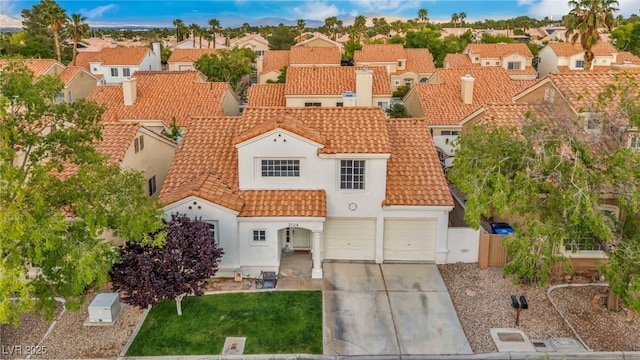 2124 Rising Mist St, Las Vegas, NV 89134 - mediterranean / spanish house featuring driveway, a residential view, a tile roof, and stucco siding