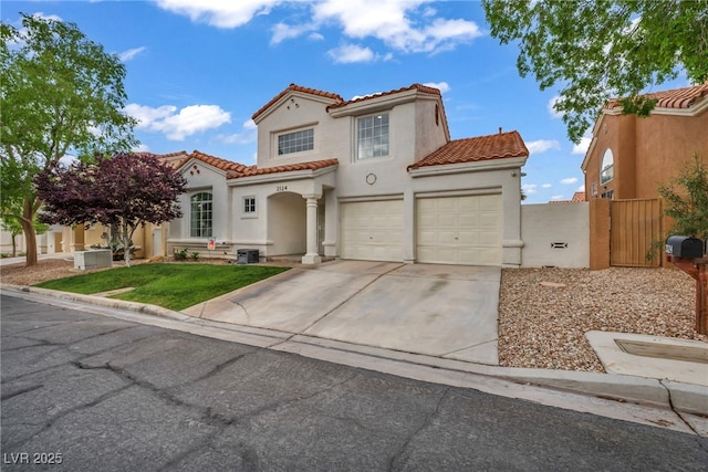 2124 Rising Mist St, Las Vegas, NV 89134 - mediterranean / spanish-style house featuring a tiled roof, concrete driveway, stucco siding, and a gate