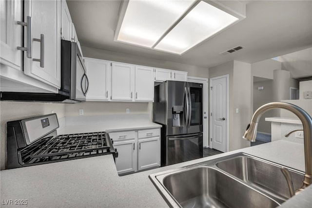 2124 Rising Mist St, Las Vegas, NV 89134 - kitchen with stainless steel appliances, a sink, white cabinetry, and light countertops