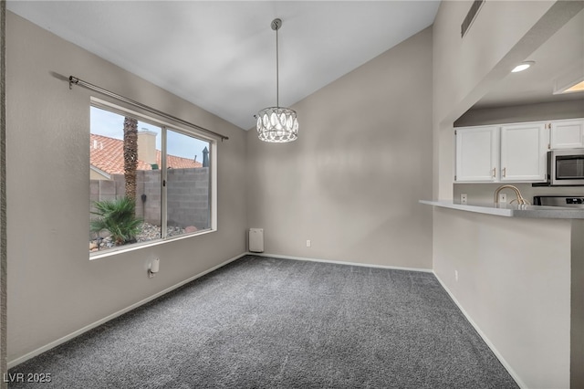 2124 Rising Mist St, Las Vegas, NV 89134 - unfurnished dining area featuring carpet, lofted ceiling, a chandelier, and baseboards