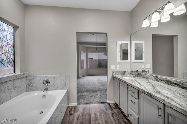 2124 Rising Mist St, Las Vegas, NV 89134 - bathroom with wood finished floors, vanity, a bath, and baseboards