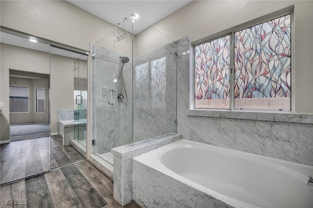 2124 Rising Mist St, Las Vegas, NV 89134 - bathroom featuring a shower stall, wood finished floors, a garden tub, and plenty of natural light