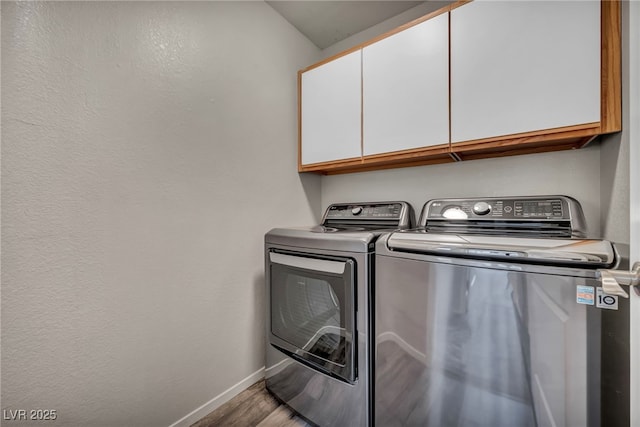 2124 Rising Mist St, Las Vegas, NV 89134 - clothes washing area featuring cabinet space, washer and dryer, wood finished floors, and baseboards