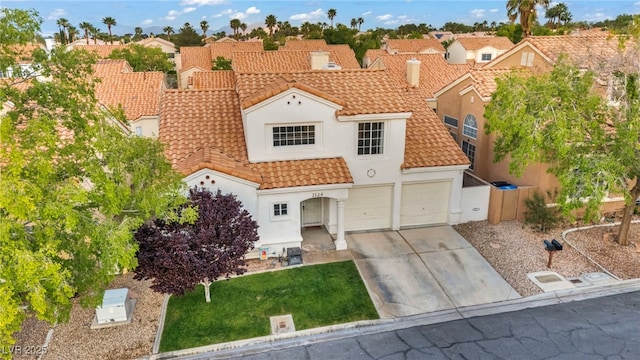 2124 Rising Mist St, Las Vegas, NV 89134 - mediterranean / spanish-style house featuring driveway, stucco siding, a tiled roof, and a residential view