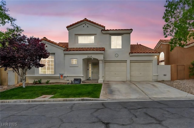 2124 Rising Mist St, Las Vegas, NV 89134 - mediterranean / spanish-style house with a tile roof, concrete driveway, stucco siding, and an attached garage
