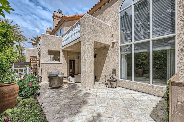 view of patio / terrace with an outdoor hangout area and a balcony