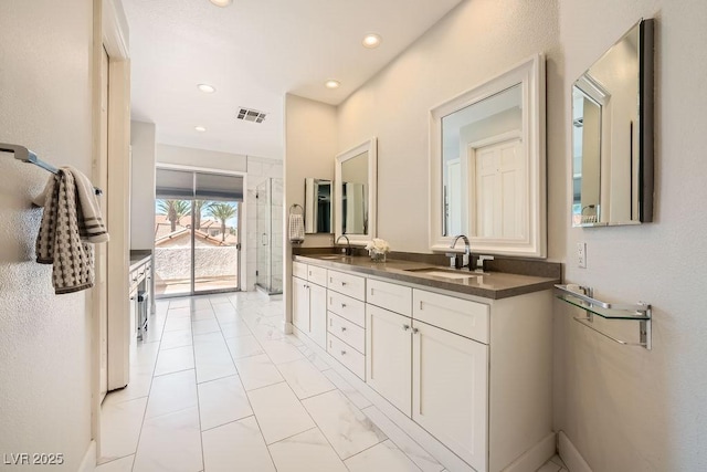 full bathroom featuring marble look tiles, double vanity, recessed lighting, and an enclosed shower