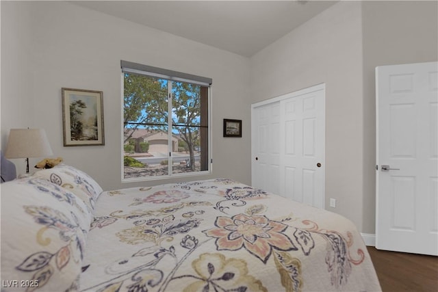 bedroom with dark wood-style flooring and a closet