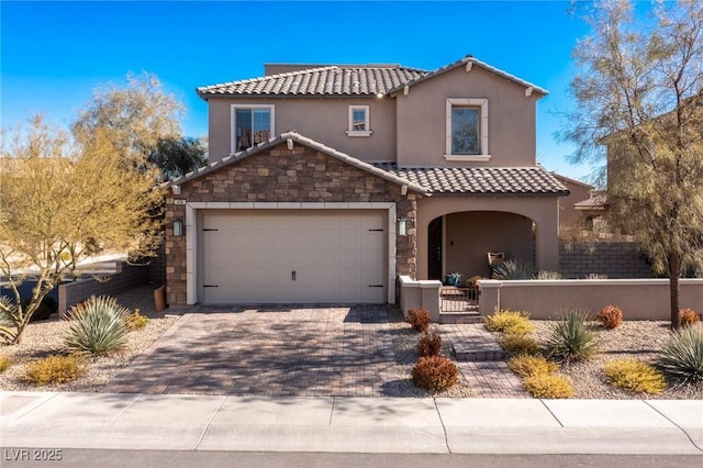 436 Trevinca St, Las Vegas, NV 89138 - mediterranean / spanish home featuring a fenced front yard, a tile roof, stone siding, stucco siding, and driveway