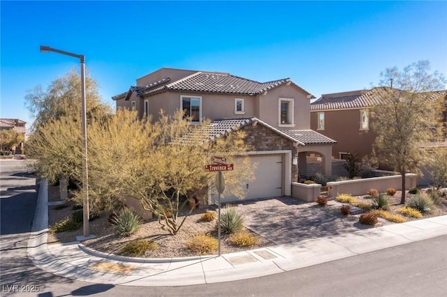 436 Trevinca St, Las Vegas, NV 89138 - mediterranean / spanish-style house featuring a tile roof, stucco siding, driveway, an attached garage, and stone siding