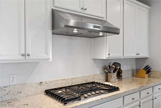 436 Trevinca St, Las Vegas, NV 89138 - kitchen featuring under cabinet range hood, stainless steel gas cooktop, white cabinetry, and light stone countertops