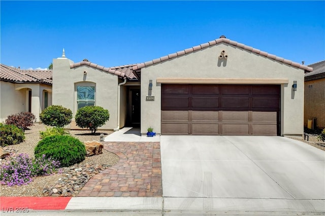3712 Rocklin Peak Ave, North Las Vegas, NV 89081 - mediterranean / spanish home with an attached garage, stucco siding, concrete driveway, and a tiled roof