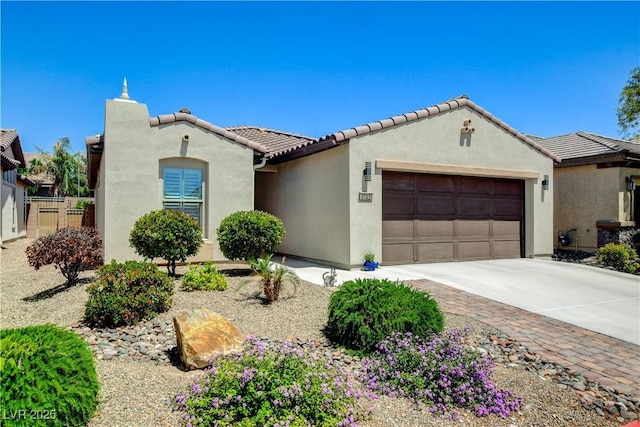 3712 Rocklin Peak Ave, North Las Vegas, NV 89081 - mediterranean / spanish-style house featuring a garage, stucco siding, concrete driveway, and a tiled roof
