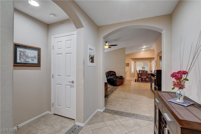 3712 Rocklin Peak Ave, North Las Vegas, NV 89081 - foyer entrance with light tile patterned floors, arched walkways, a ceiling fan, and baseboards