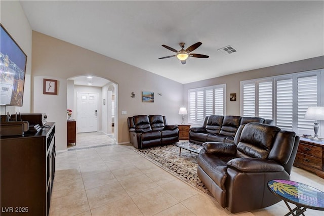 3712 Rocklin Peak Ave, North Las Vegas, NV 89081 - living area with vaulted ceiling, arched walkways, ceiling fan, light tile patterned floors, and baseboards