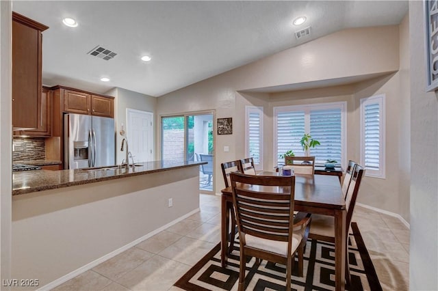 3712 Rocklin Peak Ave, North Las Vegas, NV 89081 - dining space with vaulted ceiling, recessed lighting, baseboards, and light tile patterned floors
