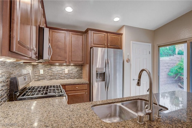 3712 Rocklin Peak Ave, North Las Vegas, NV 89081 - kitchen with stainless steel appliances, a sink, light stone counters, backsplash, and recessed lighting