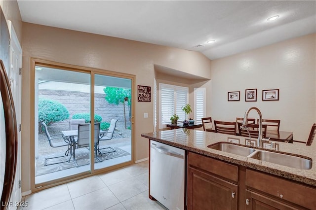 3712 Rocklin Peak Ave, North Las Vegas, NV 89081 - kitchen featuring stainless steel dishwasher, a sink, light stone counters, healthy amount of natural light, and vaulted ceiling