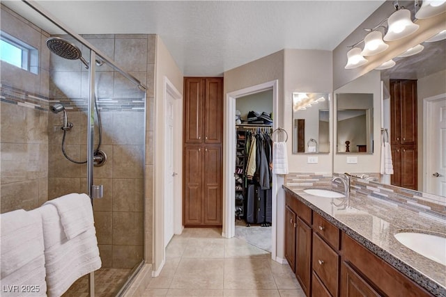 3712 Rocklin Peak Ave, North Las Vegas, NV 89081 - bathroom with a stall shower, double vanity, tile patterned floors, and a spacious closet
