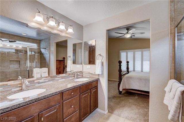 3712 Rocklin Peak Ave, North Las Vegas, NV 89081 - full bath with tiled shower, ceiling fan, double vanity, baseboards, and ensuite bathroom